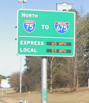 An overhead electronic sign shows the I-75 and I-675 Express lanes moving at 65 mph and Local lanes at 59 mph.